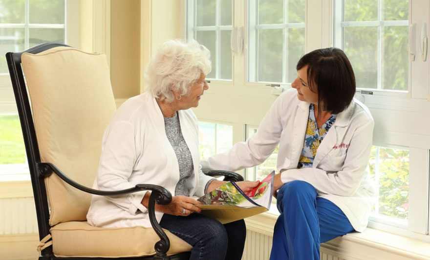 image of resident and nurse at Sunnyside Manor